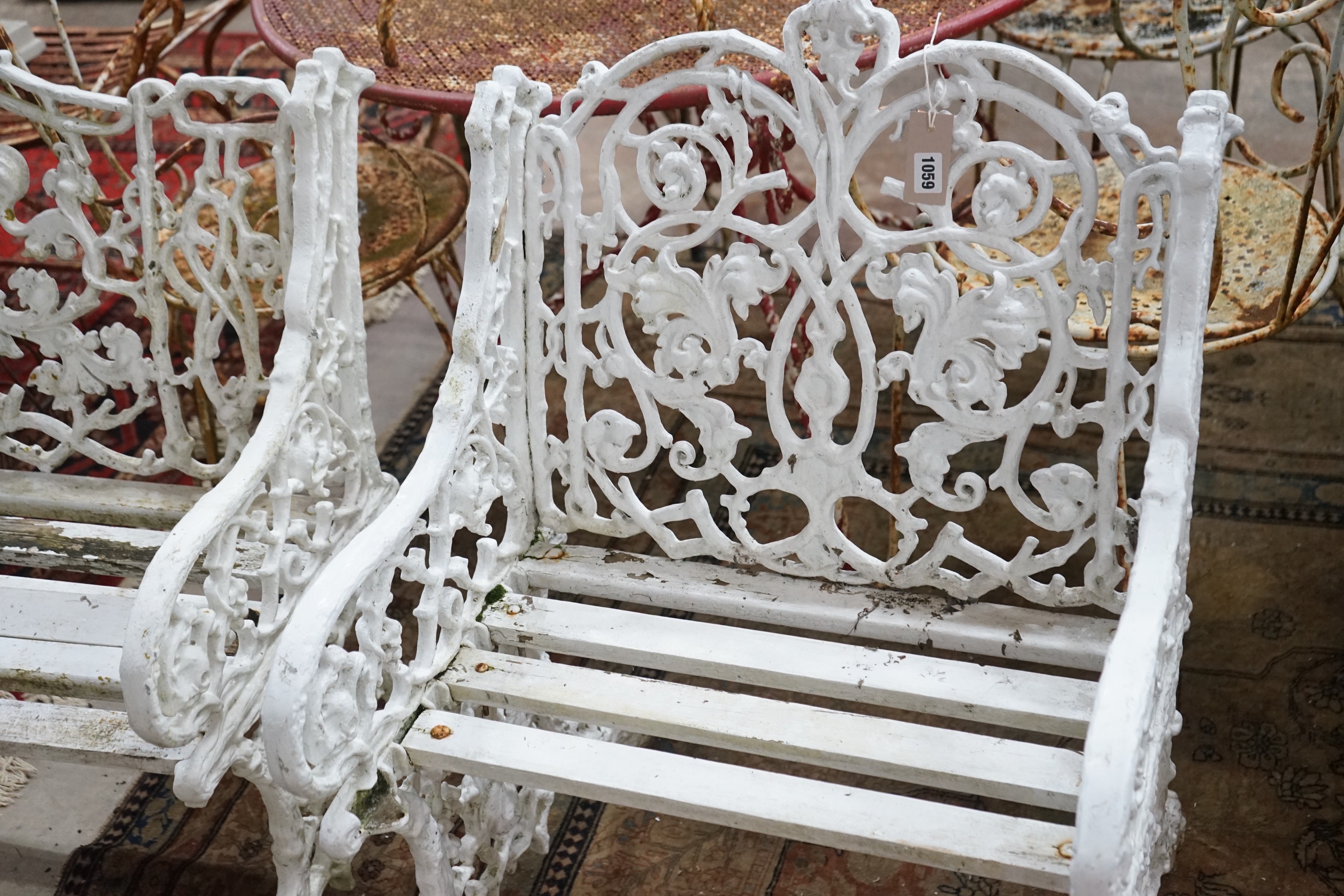 A Victorian style cast metal slatted garden bench, length 127cm, depth 60cm, height 86cm and two chairs